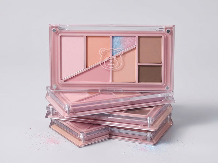 eyeshadow palette stacked on a grey background 