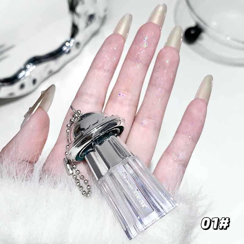 ClearEyeshadow Palette bottle held by a hand with glittery nails on a white background