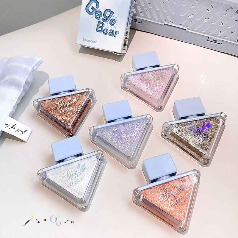 Set of glittery Eyeshadow palette with 'Gege Bear' branding on a light surface.