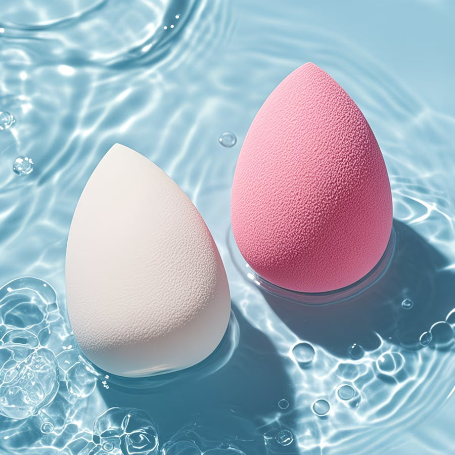 2 egg shaped beauty blender deeped in the clear water 