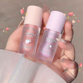 Two small bottles of 'Gege bear' product held by a hand against a neutral background.