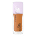 Maybelline Super Stay foundation bottle with purple cap on a white background