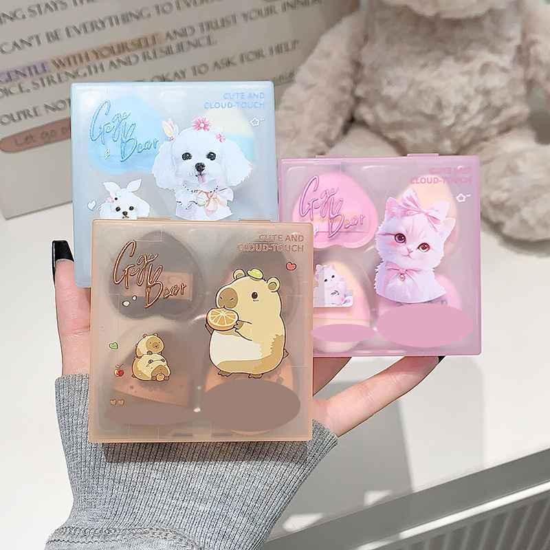 Cute animal-themed beauty blender pack of 3 held by a person, with a soft toy in the background. Teddy bear on the back 