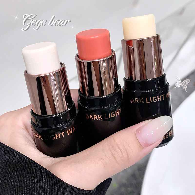 Three Blush held in a hand with a blurred background