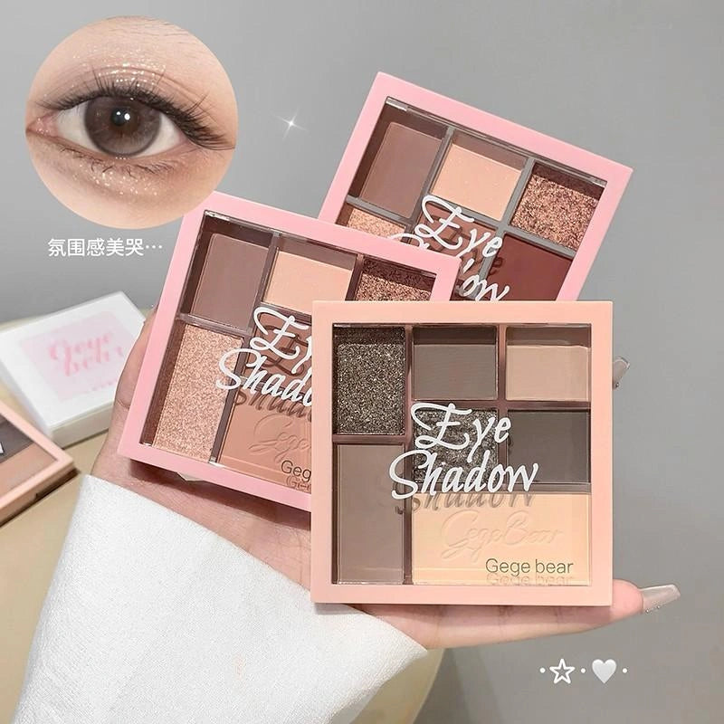 Eyeshadow palettes with 'Gegebear' branding held by a hand, close-up of an eye wearing makeup.