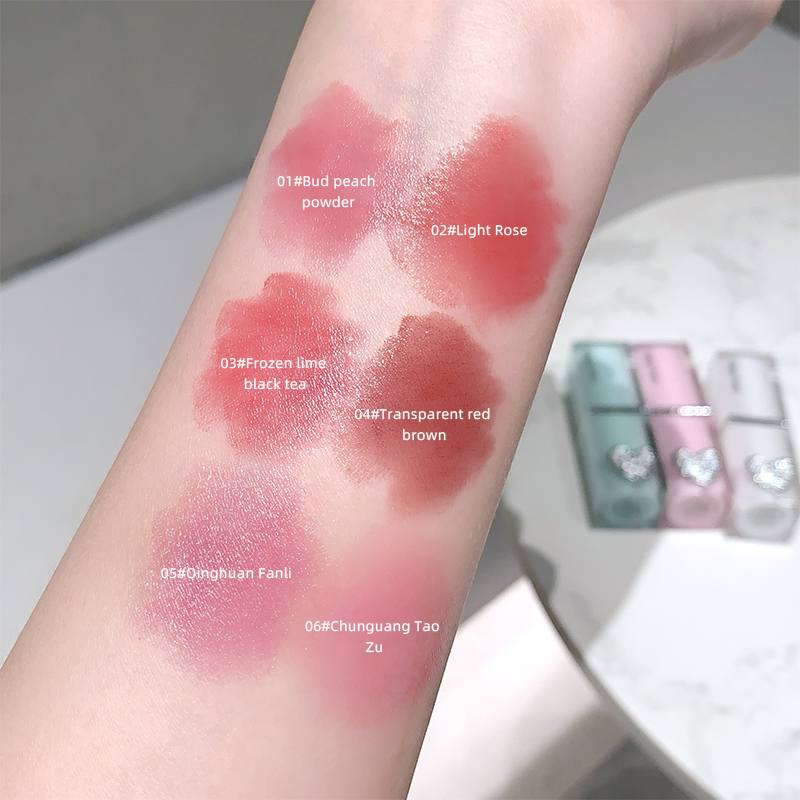 Color swatches on a person's arm with labeled makeup shades.