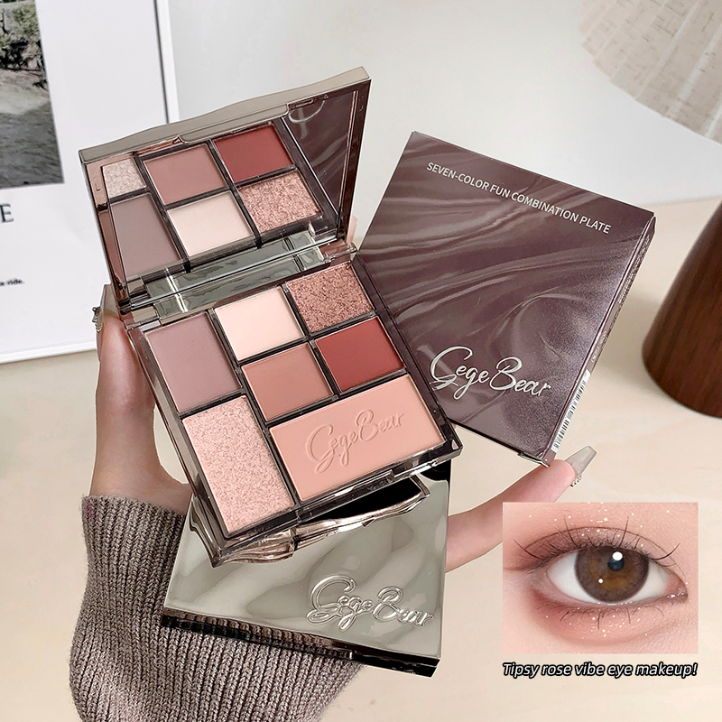makeup eyeshadow palette held on the hand along with the packaging and a eye showing the detials of how it looks against the white background 