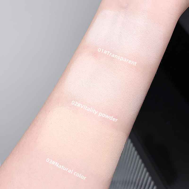 Arm swatches of different compact powder shades on a neutral background