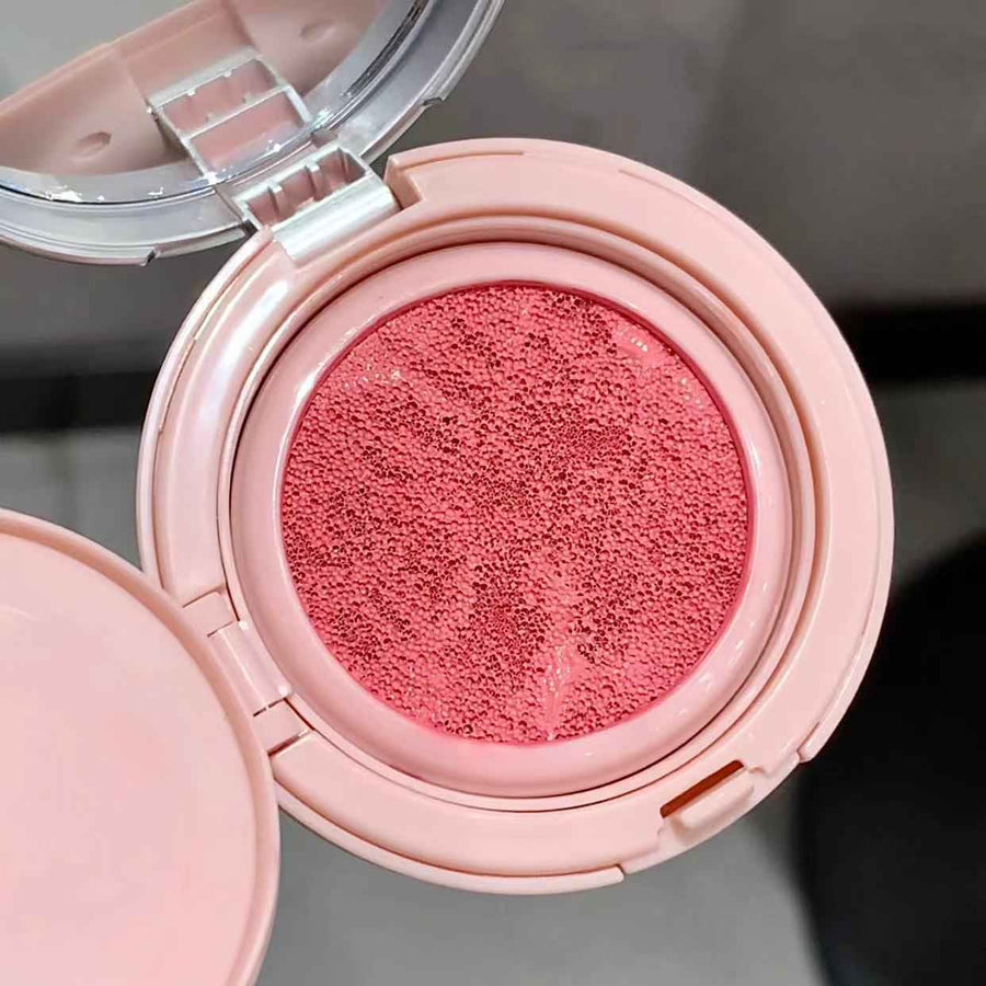 Blush with open lid showing blush color on a neutral background