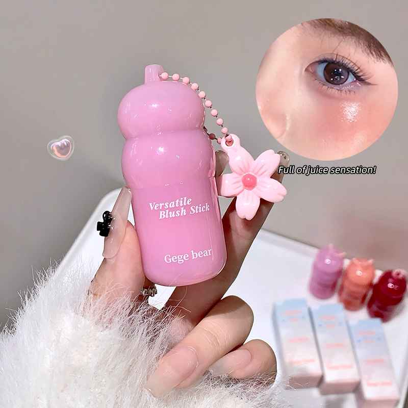 Pink blush stick with decorative elements held by a hand, close-up of blush application on skin, and additional blush sticks in the background.