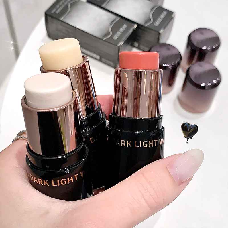 Three Blush sticks with visible brand name held by a hand on a blurred background