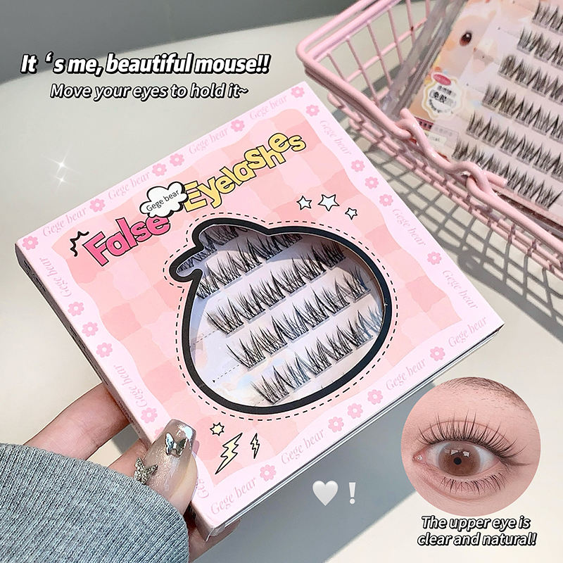 Box of false eyelashes with a hand holding it and an inset showing an eye with the lashes applied.