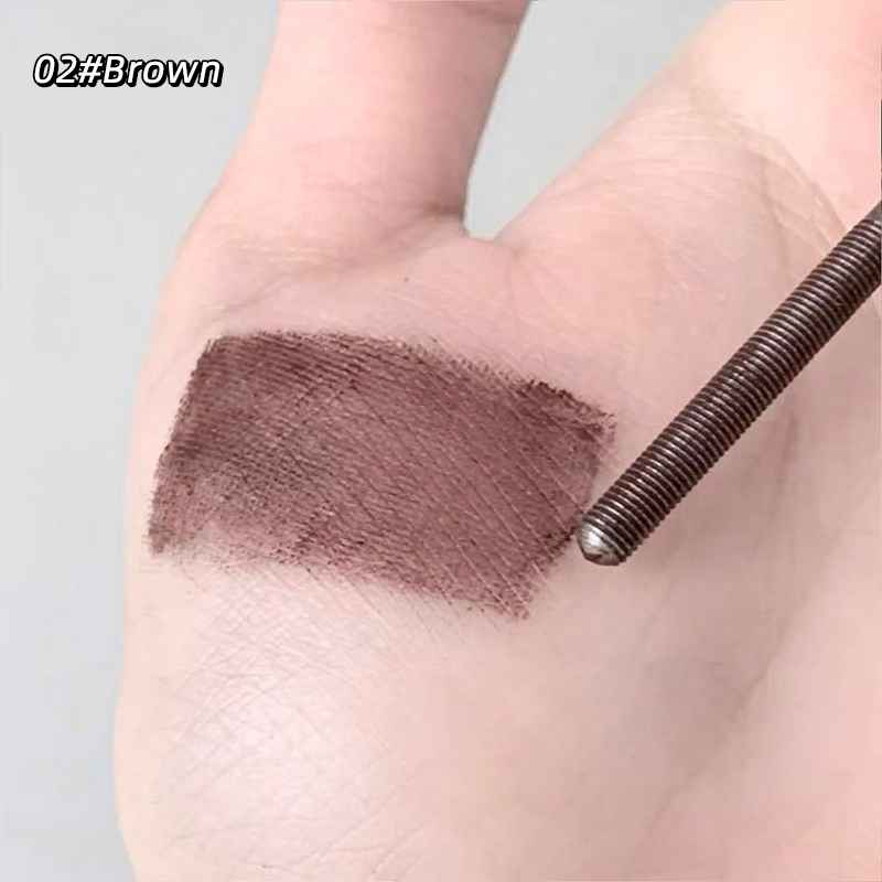 Brown mascara swatch on a hand with a gray background