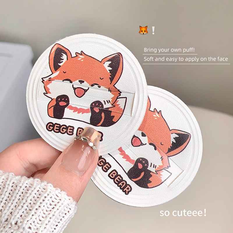 Cartoon fox face compact powder with a hand holding it, labelled 'GEGE BEAR'.