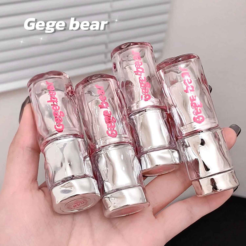 Clear lip gloss tubes with pink text held in a hand, branded 'Gege bear'.
