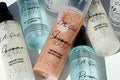 Collection of L.A. Girl makeup spray bottles on a light background