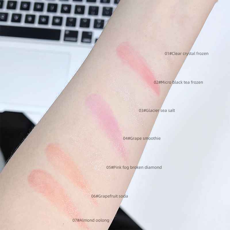 Color swatches on a person's arm with a laptop in the background