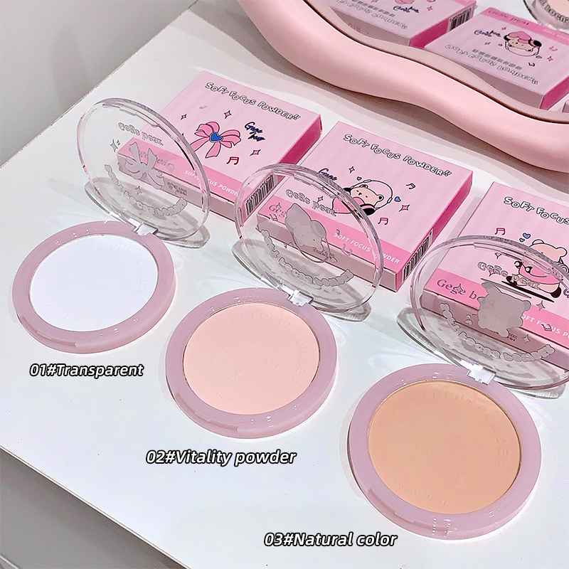 Compact powder with pink packaging and three color options on a white surface.