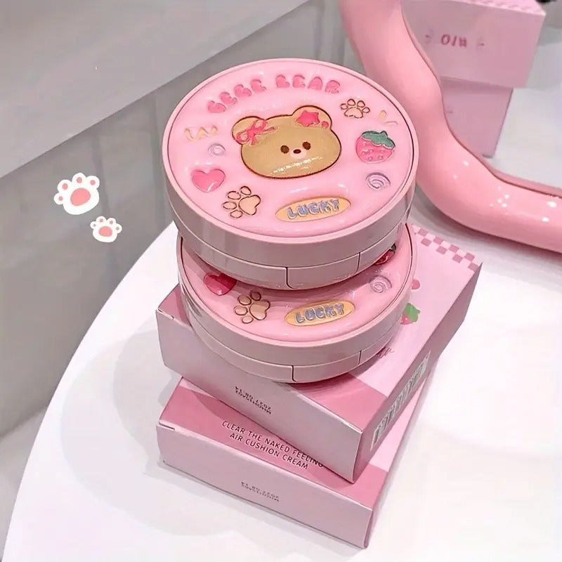 Pink container of foundation with bear design on a white background