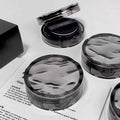 Cushion foundation with a mirror on a white surface