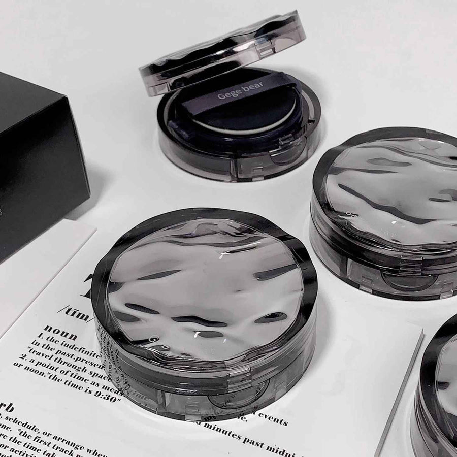 Cushion foundation with a mirror on a white surface