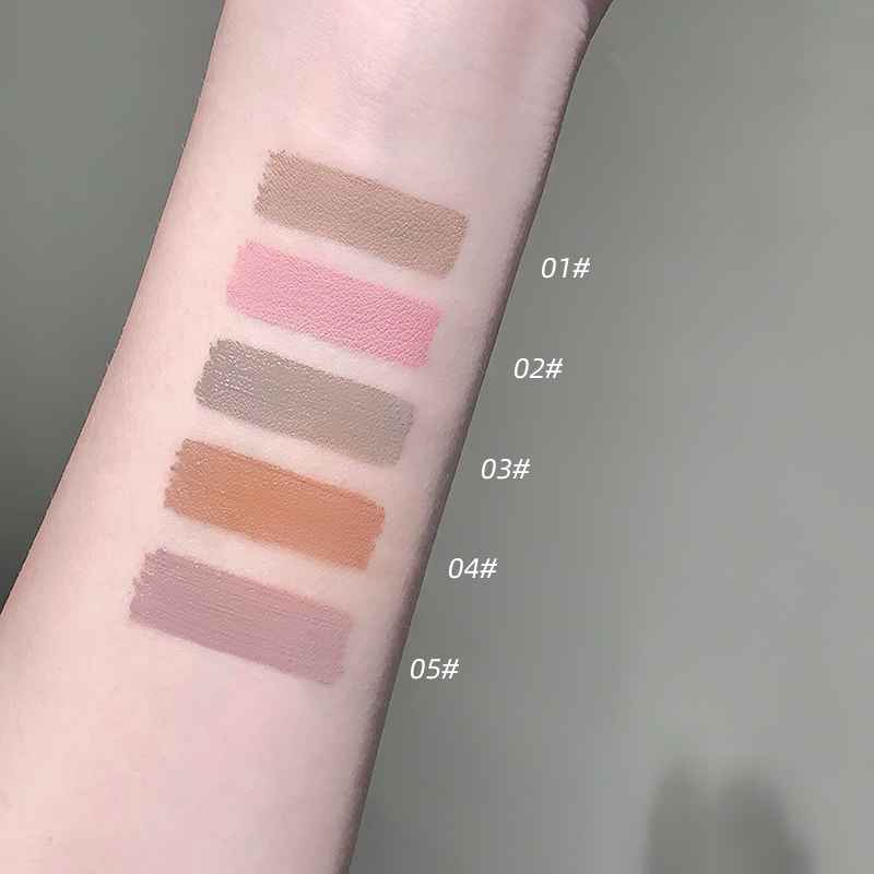 Color swatches on a person's arm with labeled shades against a neutral background