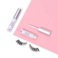 Eyelash adhesive and applicators on a pink background