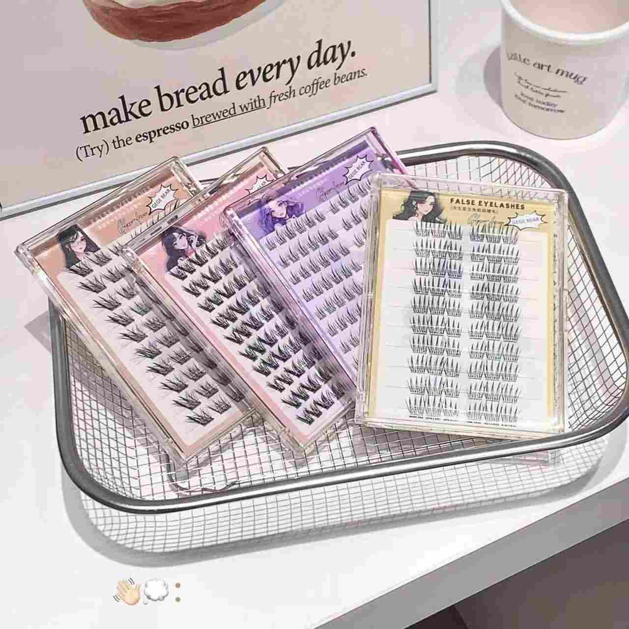 False eyelashes in packaging on a metal tray with a magazine in the background.
