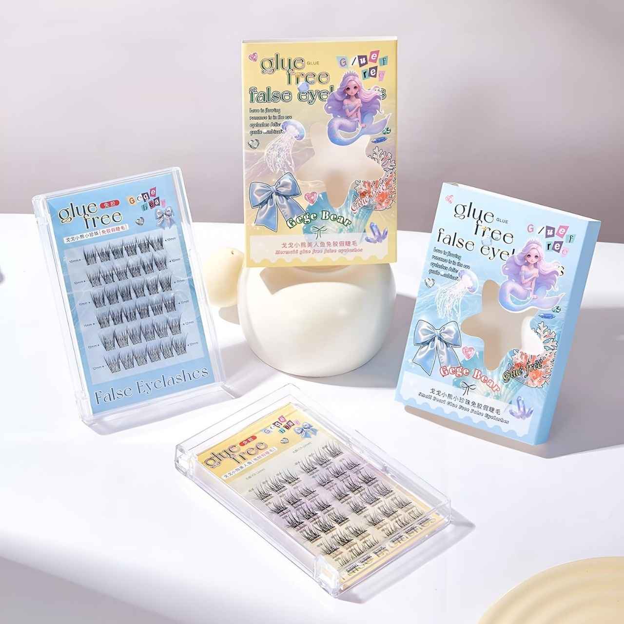 False eyelashes packaging with mermaid design on a white surface