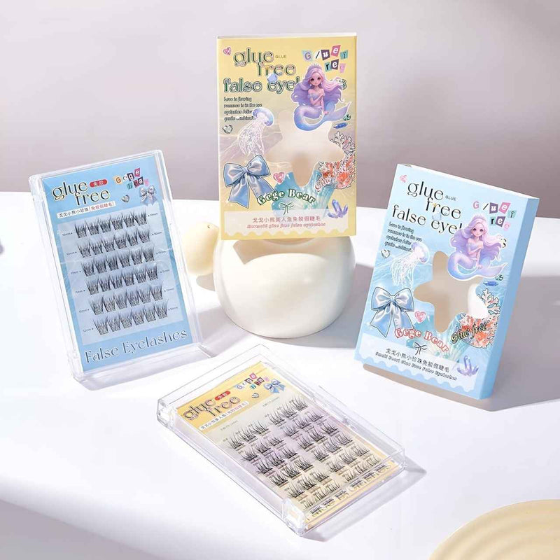 False eyelashes packaging with mermaid design on a white surface