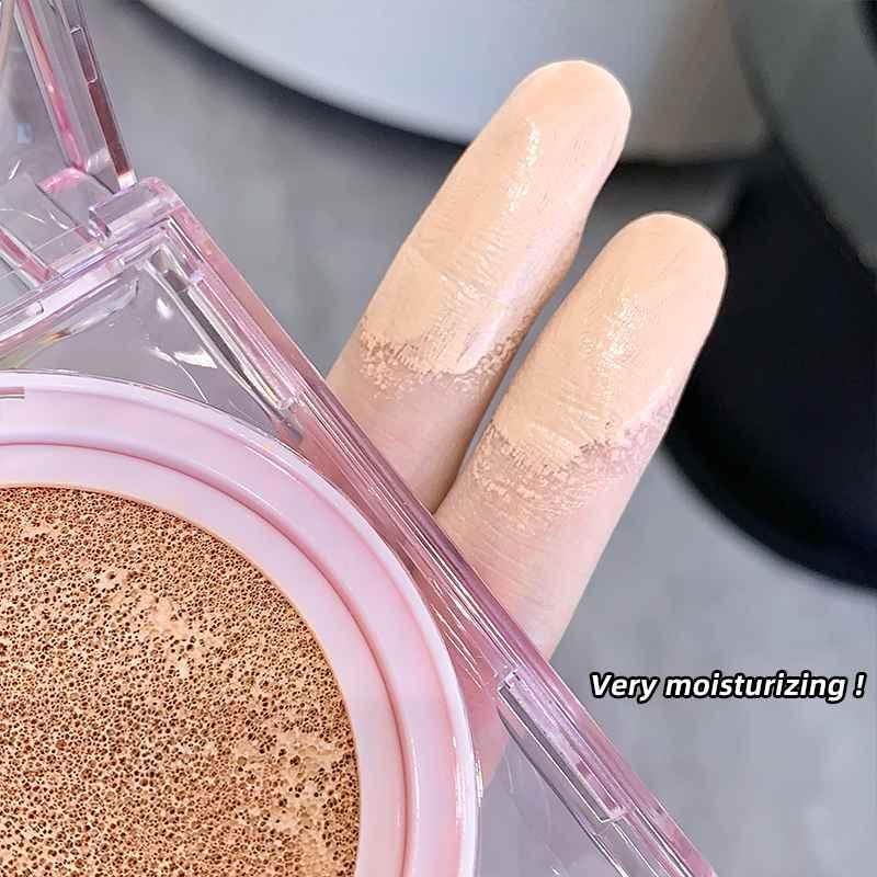 Two fingers holding Gege Bear liquid matte cushion foundation compact, showing product composition, packaging design, and K-beauty inspired cushion formula.