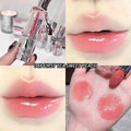 Lip gloss with 'Gege Bear branding, applied on lips and swatched on skin.