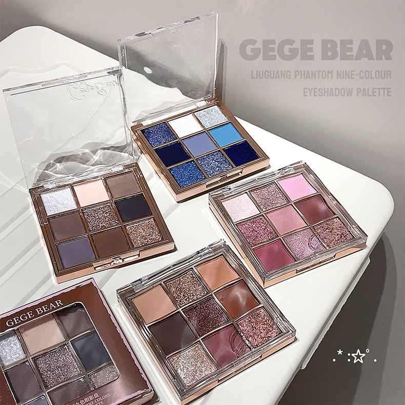 Multiple GEGE BEAR eyeshadow palettes on a white surface with a gray background showing pigmentation variations
