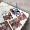 Multiple GEGE BEAR glitter eyeshadow palettes on a white surface with a gray background showing pigmentation variations