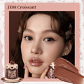 FlowerKnows Sweetie Bear Coating Lip Jelly lip gloss in JE08 Croissant shade applied on lips showing soft warm nude tint and glossy shine effect.