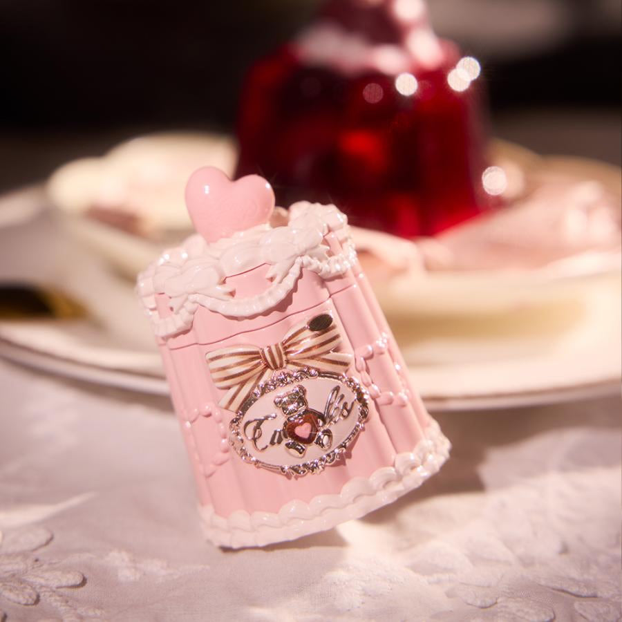 Flower Knows Sweetie Bear Coating Lip Jelly lip gloss in a pink decorative container tilted toward the left, featuring a glossy finish and signature heart-shaped knob design.
