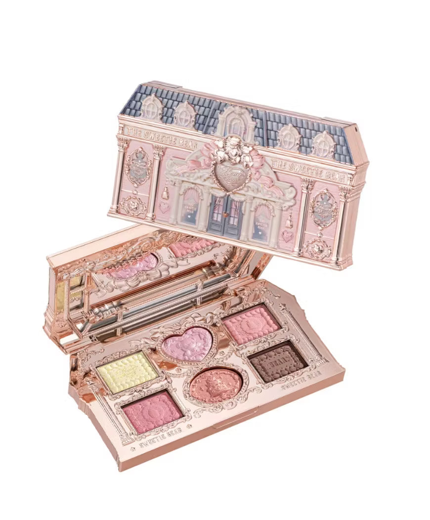 An overhead shot on a white background showing the open Flowerknows romantic nude pink eyeshadow palette with its classy dollhouse-inspired packaging, displaying six pigmented swatches of the four soft matte and two sparkling shimmer shadow cakes.