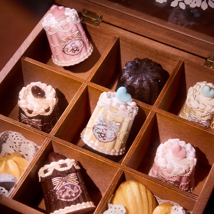 Flowerknows Sweetie Bear Coating Lip Jelly lip gloss arranged in a wooden display box with 9 individual compartments, each compartment holding a lip gloss in place, showcasing the decorative packaging and glossy finish.