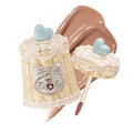 Flowerknows Sweetie Bear Coating Lip Jelly JE01 Fluffy Toast shade lip gloss swatch showing soft nude brown tint and glossy shine on lips against white background.