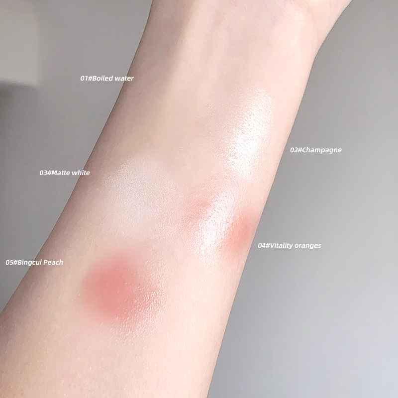 Close-up of a person's arm with different colored Blushes swatches on a neutral background.