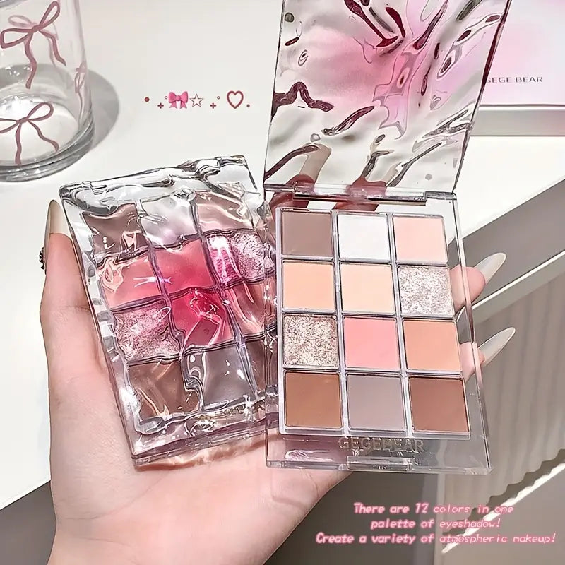 Makeup eyeshadow palette with pink and silver design held by a hand