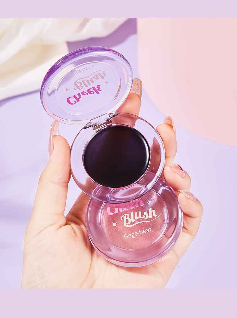 Hand holding a pink blush compact with 'Gege Bear' branding on a light purple background