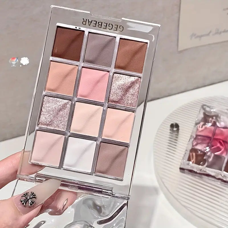 Makeup eyeshadow palette with various shades held by a hand, brand 'GEGE BEAR' visible.
