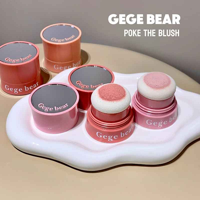 Gege Bear blush products on a white stand with a beige background