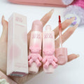 Pink GEGE BEAR cosmetic products held by a hand on a white background