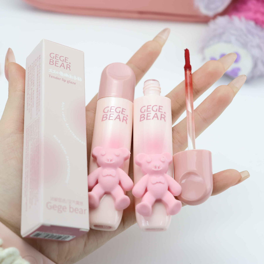Pink GEGE BEAR cosmetic products held by a hand on a white background