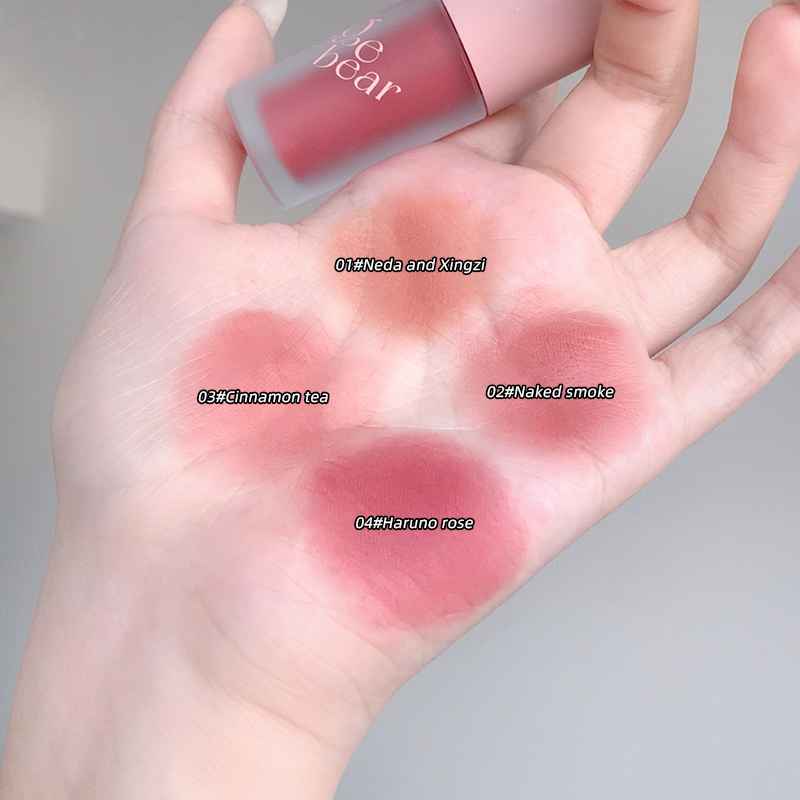 Hand displaying swatches of different Gege bear glosses colors with a brand name in the corner.