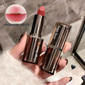 Gege bear lipstick with packaging held by a hand, close-up of lipstick color swatch.