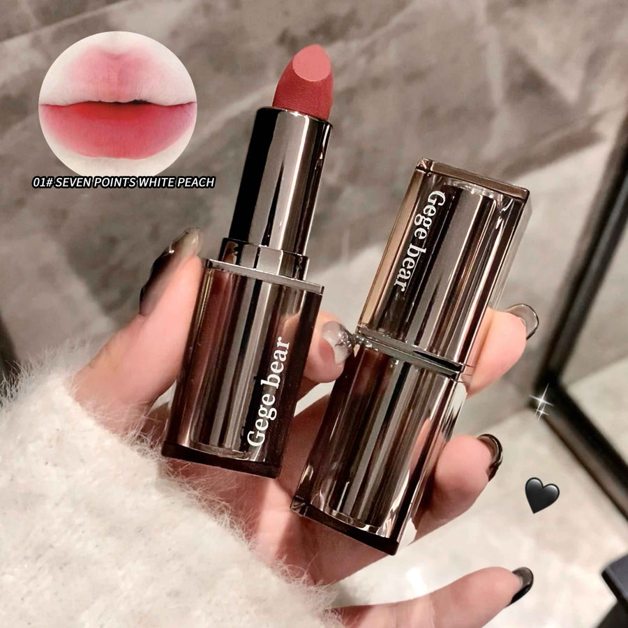 Gege bear lipstick with packaging held by a hand, close-up of lipstick color swatch.