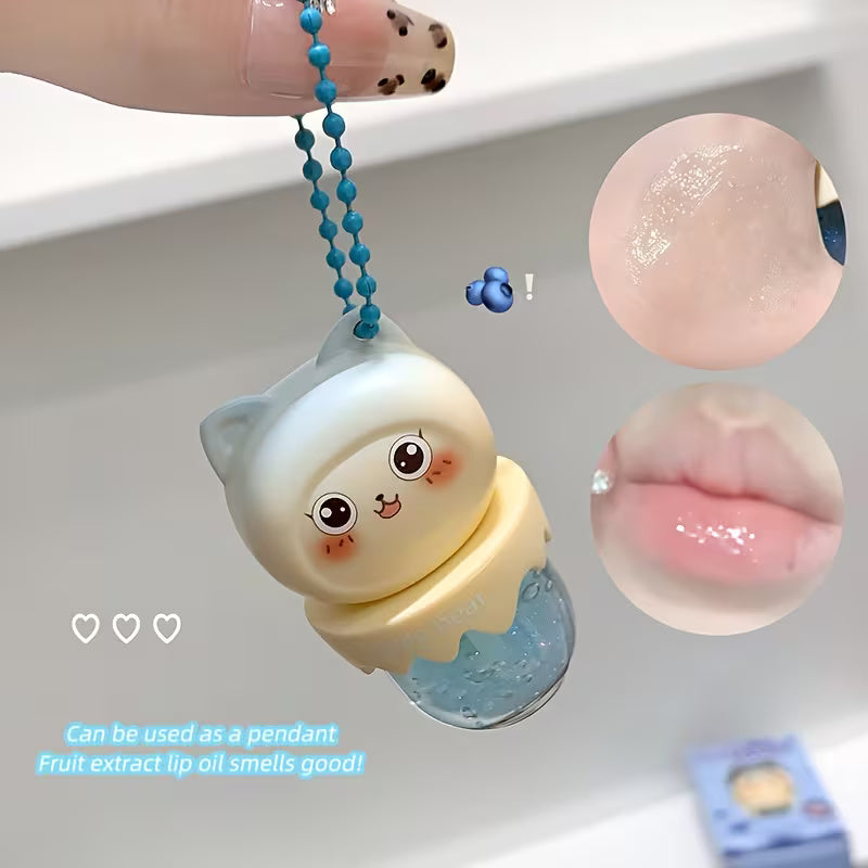 Clear lip oil in a sleek tube shown with a glossy applicator, reflecting a soft, luminous shine. The product appears lightweight and moisturizing, suggesting smooth, hydrated lips with a natural, non-sticky finish.